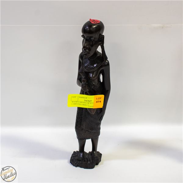 WOOD CARVING OF A LADY CARRYING OBJECT
