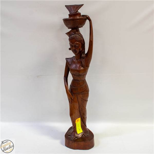 WOOD CARVING OF A LADY CARRYING BASKET