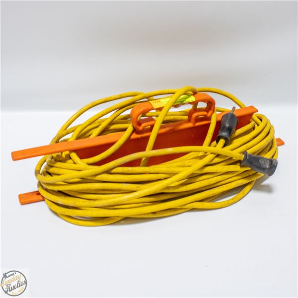 YELLOW EXTENTION CORD ON PLASTIC CORD STORAGE