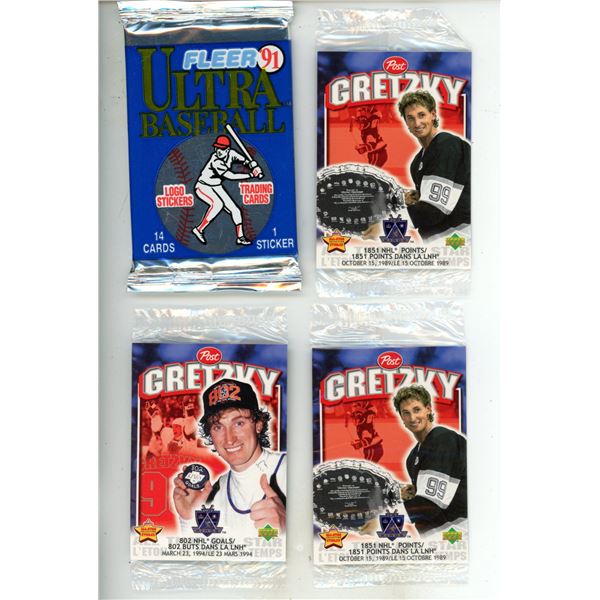 Vintage sports trading cards and sticker packs from the early 1990s, specifically showing sealed Fle