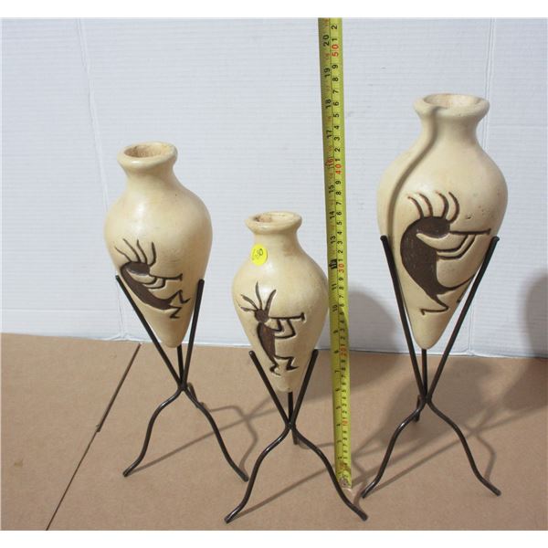 3 Clay Uases In Racks. (3 Different Sizes)