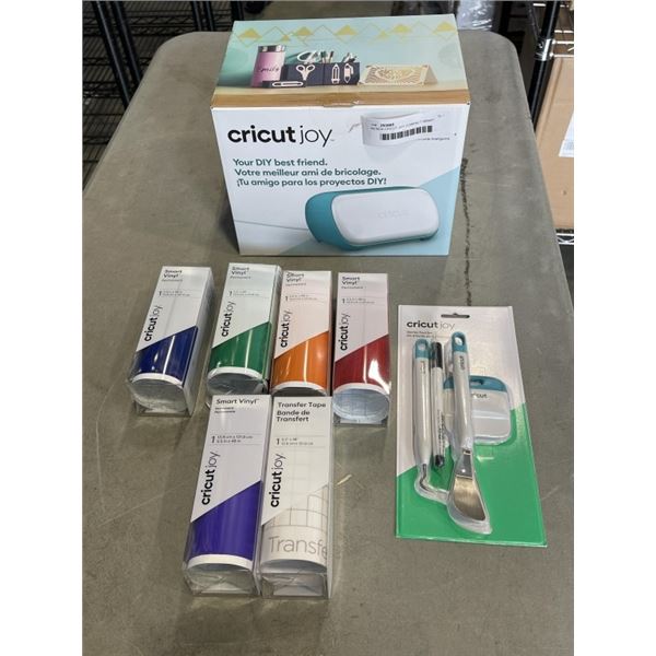 AS NEW CRICUT JOY COMPACT SMART CUTTING MACHINE AND 5 ROLLS OF SMART VINYL AND A CRICUT STARTER TOOL