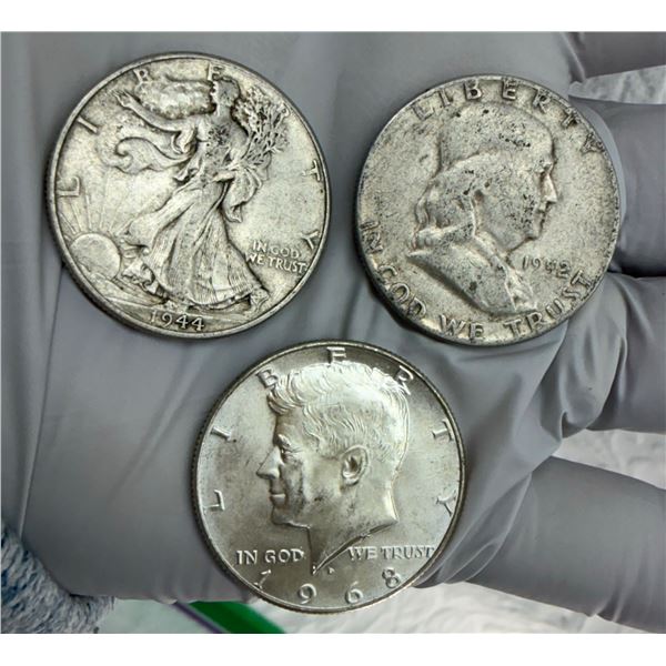 THREE DESIGNS OF THE US HALF DOLLAR: WALKING LIBERTY SILVER HALF DOLLAR, 1944; BEN FRANKLIN SILVER H