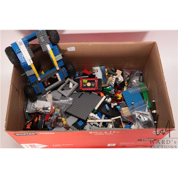 Box of loose Lego brick including some vehicles parts and Minifigures