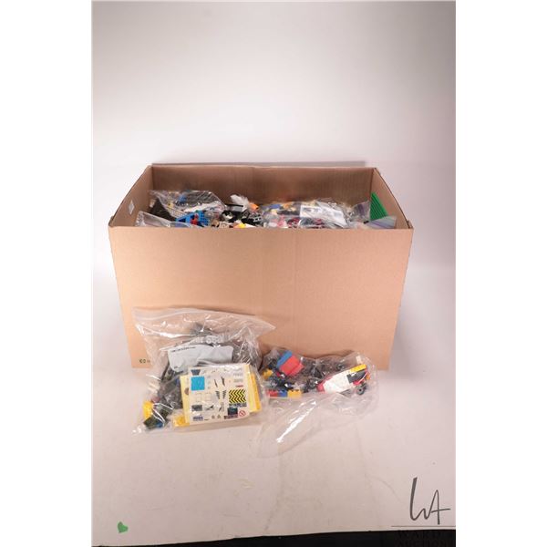 Large box containing an assortment of Lego Bricks and Minifigures