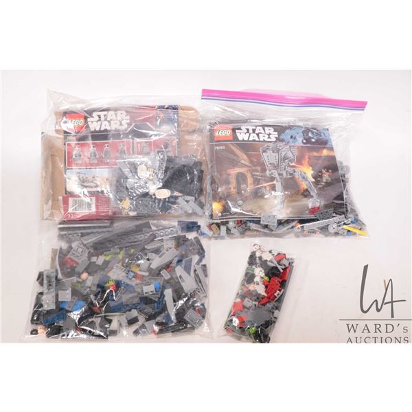 Four Lego "Star Wars" pre-built kits including no. 75153 AT-ST Walker, no. 7668 Rebel Scout Speeder,