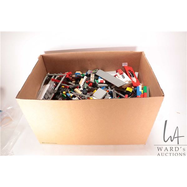 Box containing a large selection of loose Lego bricks and accessories