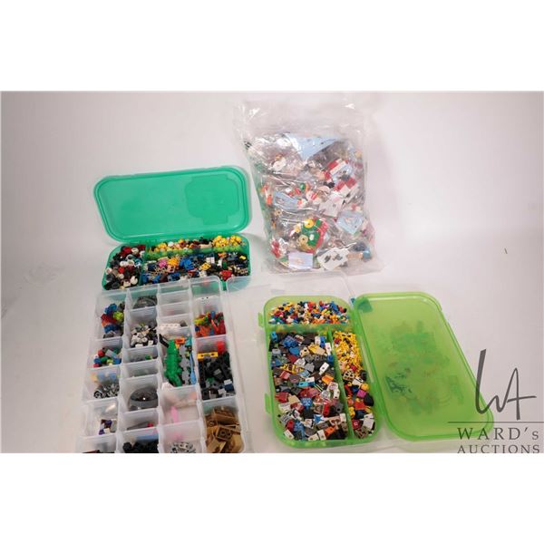 Three plastic cases containing an assortment of Minifigure pieces plus a sealed bag of small kits