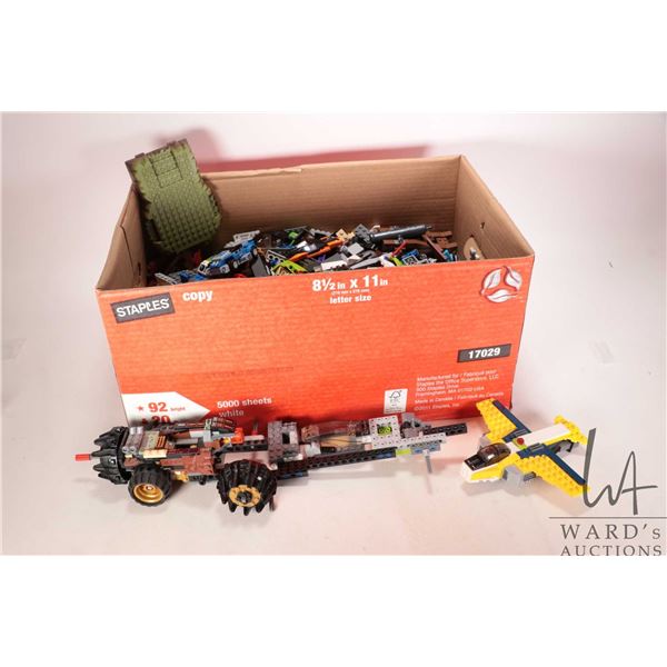 Box of assorted Lego bricks and partially built Lego vehicles