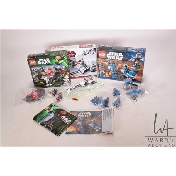 Three Lego "Star Wars" pre-built kits including no. 7194 Mandolorian Battle pack with manuals, box a