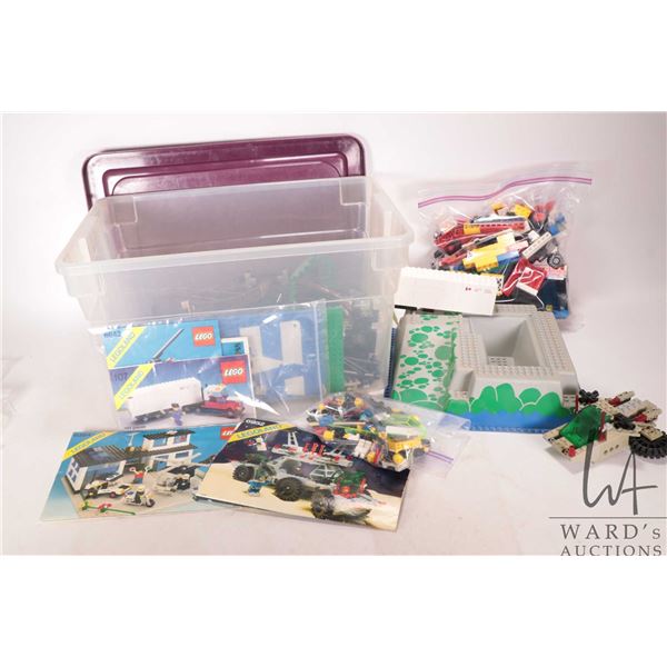 Box of older Lego bricks and bases, some assembled kits. some manuals. Bid accordingly