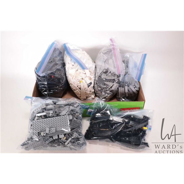 Six bags of black, grey and white Lego building bricks