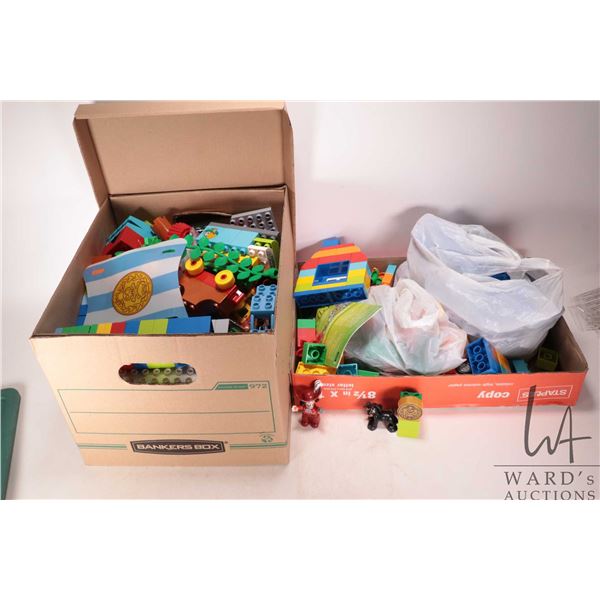 Box and flat containing a large selection of Duplo building bricks and accessories