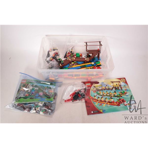 Plastic tub of Lego pre-built kits including no. 80103 Dragon Boat race, no. 21123 "Minecraft" The I