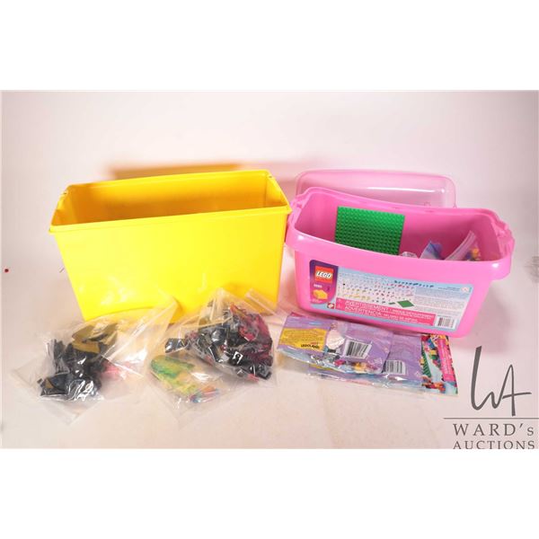 Two plastic branded Lego totes containing two factory sealed Lego Friends kits, no. 5560 large pink 