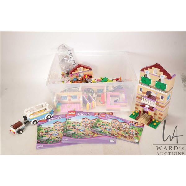 Plastic tote containing no. 3185 Lego "Friends" Summer Riding Camp pre-built kit, two Lego Friends b