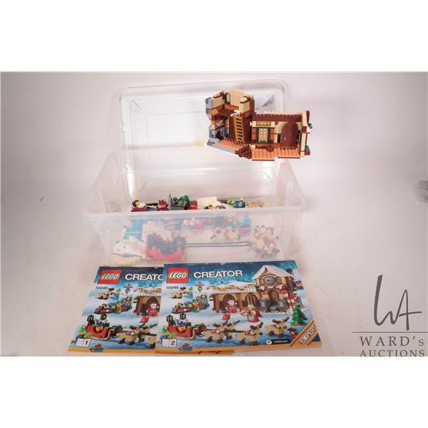 Plastic tote containing Lego Creator no. 10245 Expert Santa's Workshop pre-built kit including Minif