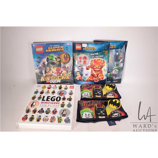 Four Lego books including two hardcover "Lego Minifigure Year by Year" with three Minifigures, "Lego