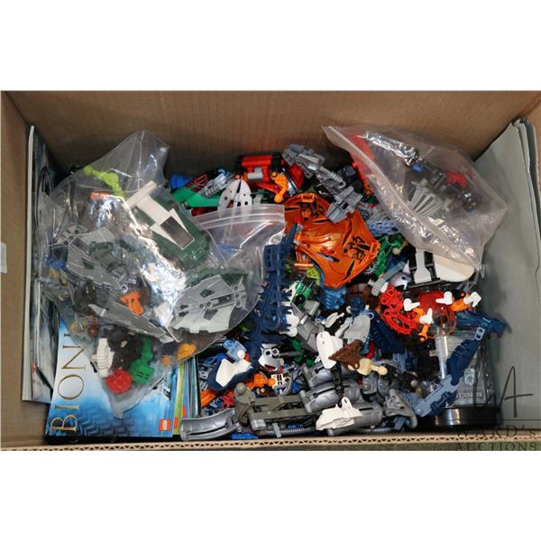 Box containing a large selection of Lego Bionicals pre-built kits.