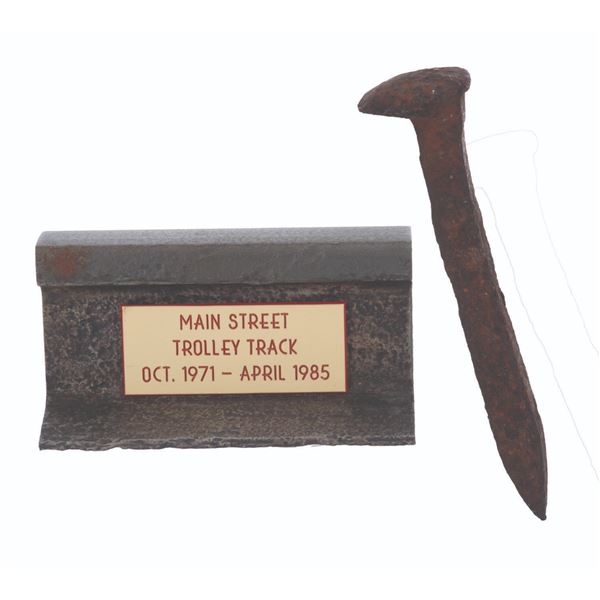 A Main St. Trolley Track Gift and Walt Disney World Railroad Spike.