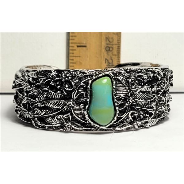 19)  HEAVILY CARVED, OPEN ENDED BANGLE