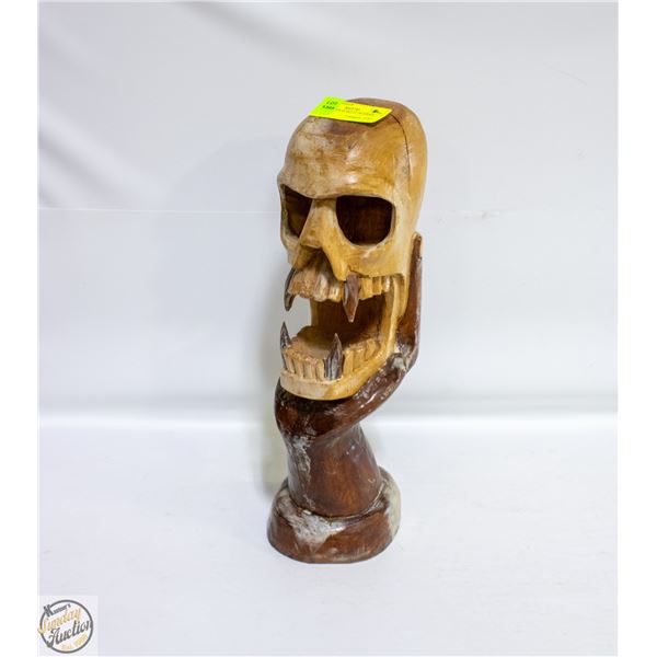 CARVED WOOD SKULL IN HAND