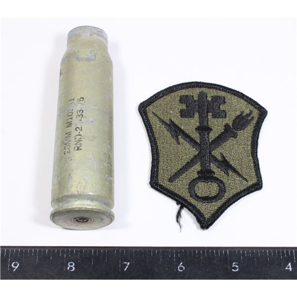 20 MM DUMMY ROUND CASING WITH A MILITARY PATCH