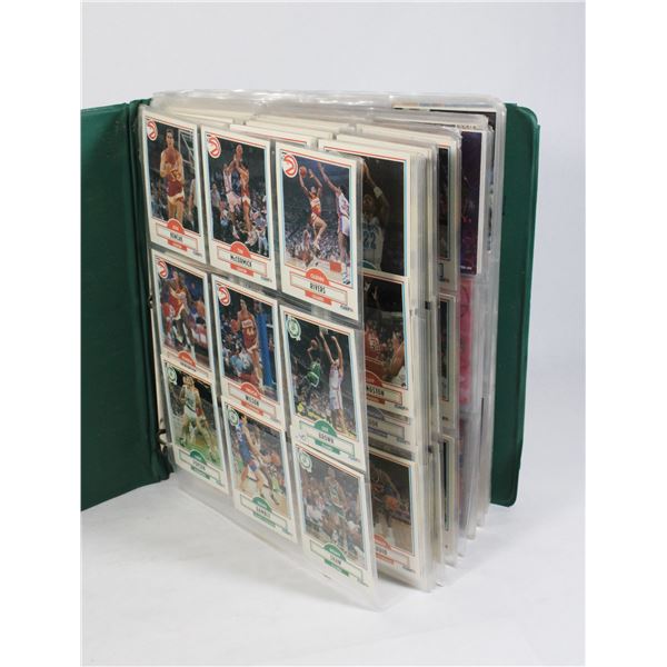 GREEN BINDER WITH BASKETBALL CARDS
