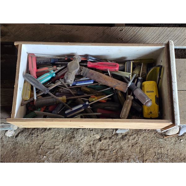 Drawer full of tools, screw drivers and hammer