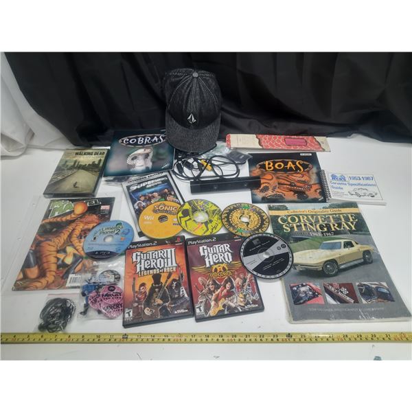 Collection of various vintage media and automotive collectibles, including video games, books, and a