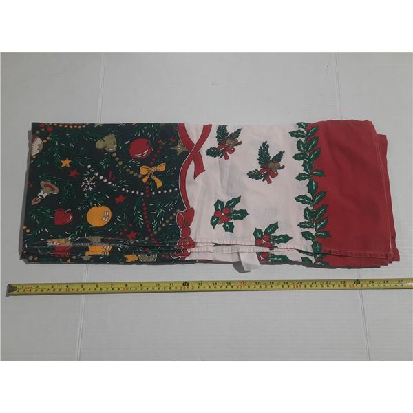 Decorative Christmas tablecloth featuring holiday patterns like ornaments, holly, and ribbon. (Made 