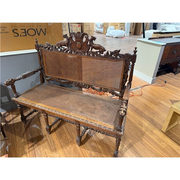 Antique Renaissance Revival Carved Settee with Detailed English Style Carvings and Rattan Seat