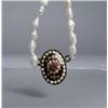 Image 1 : A Strand of Freshwater Pearls with Enamelled Ruby Pendant and Low kt Gold Clasp.