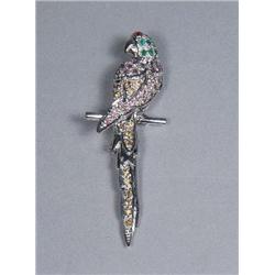 A Silver Garnet, Emerald, Amethyst and Citrine Macaw Form Brooch.
