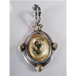 A 18 kt Yellow Gold and Sterling Pendant.