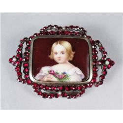 A Garnet and Porcelain Brooch.