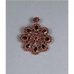 A Sterling Silver and Gold Vermeil Garnet Pendant Brooch.