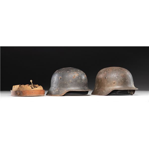 2 WWII GERMAN HELMETS AND AN EXTRA LINER.