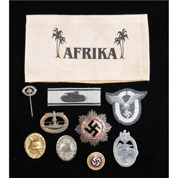 WWII STYLE GERMAN BADGES, PINS, AN ARMBAND & MORE.