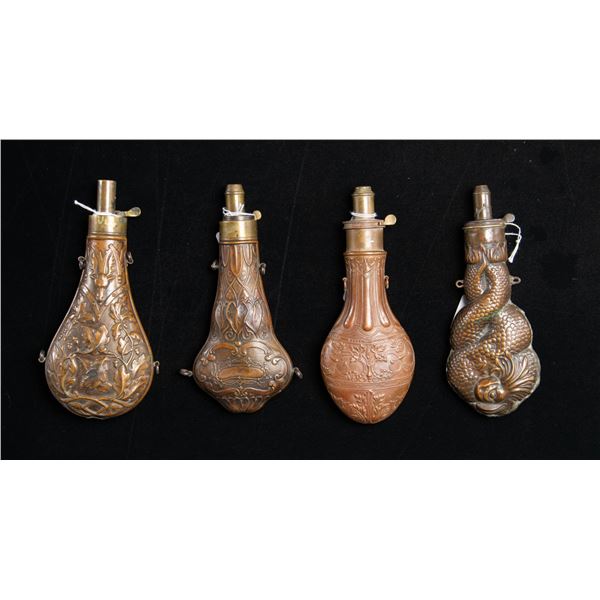 FOUR LARGE DECORATED POWDER FLASKS.