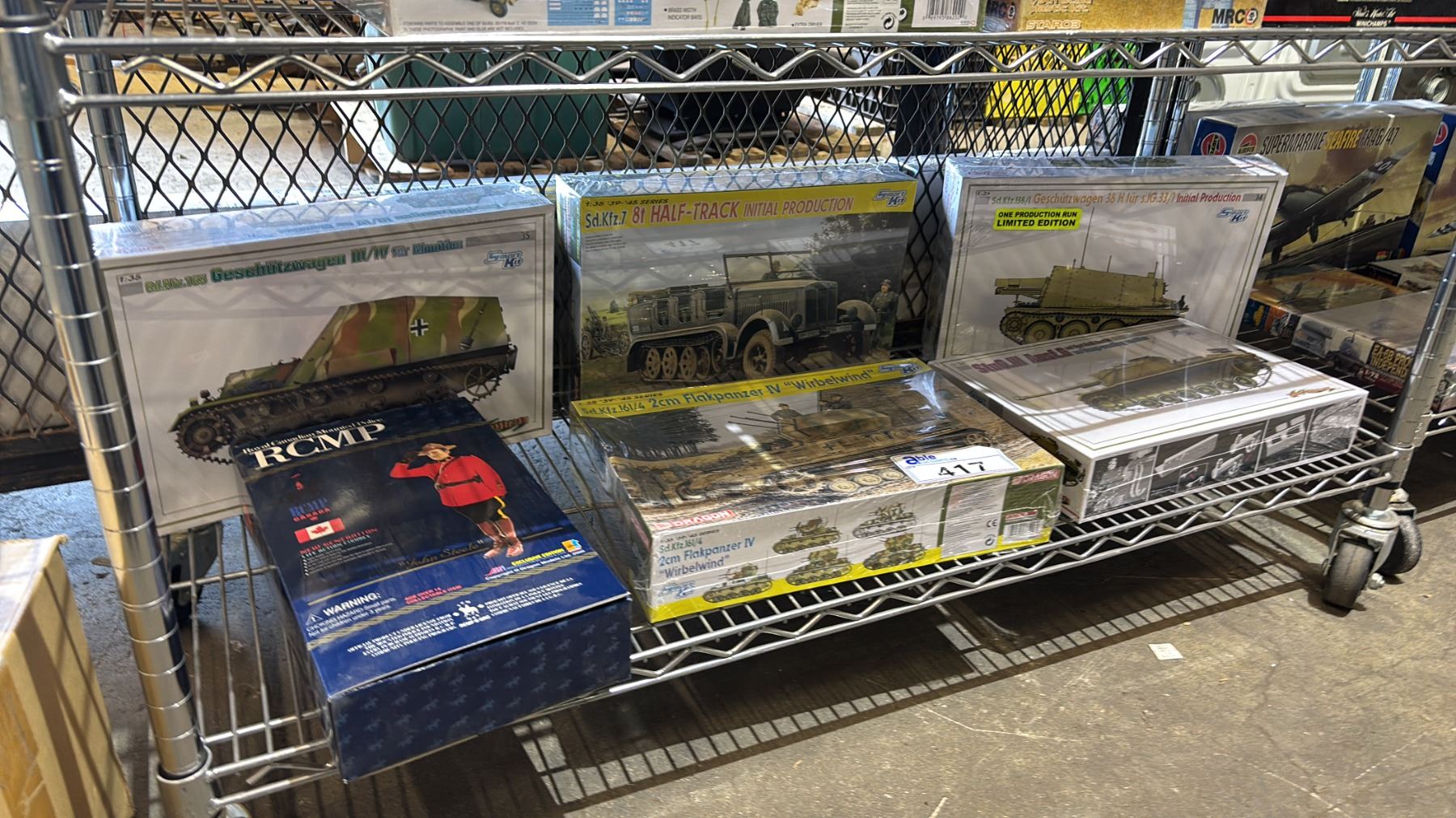 Model Tank Shelf SHELF OF ASSORTED TANK MODEL KITS & AN RCMP OFFICER