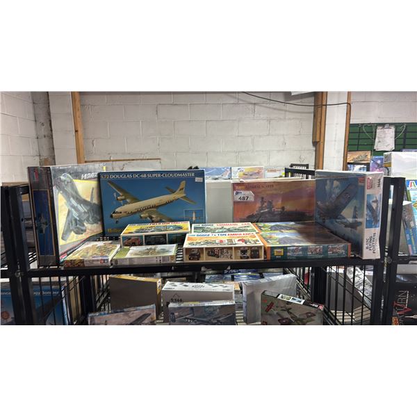 SHELF OF ASSORTED MODEL KITS: AIRPLANES, MILITARY VEHICLES, THATCHED COUNTRY HOUSES & MORE