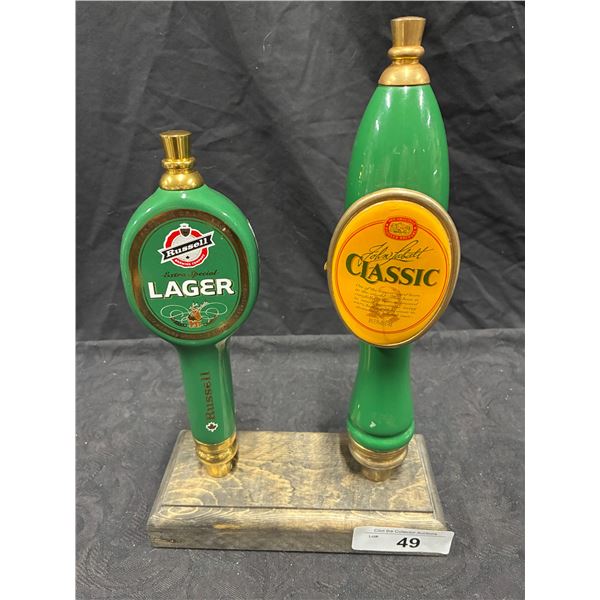 2 beer tap handles on stand