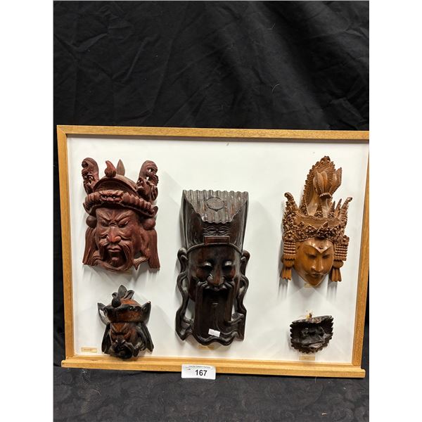 Collection of 5 wooden masks on board 24"x19"