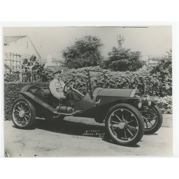 Man in Early Roadster Race Car Photo