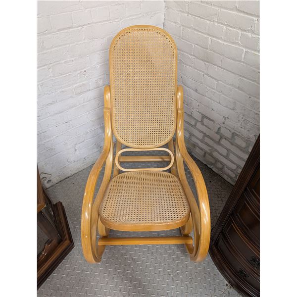Thonet-style bentwood rocking chair featuring cane webbing