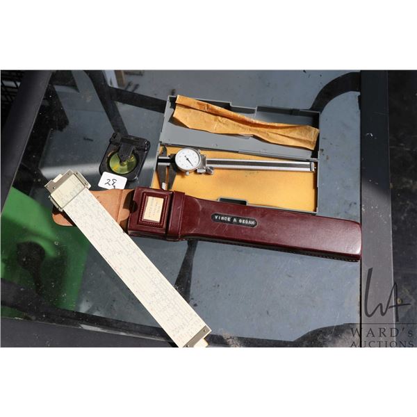 3 measuring tools including Hughes-Owens slide rule in leather case, dial calipers, and angle level 