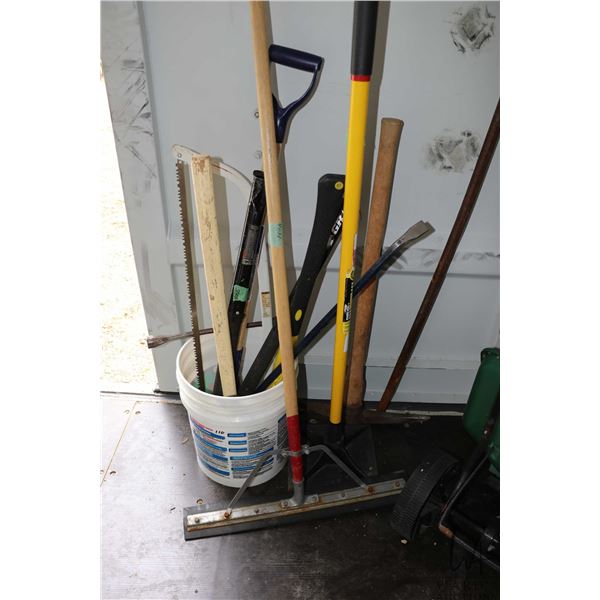 Selection of construction hand tools including axes, sledgehammers, tamper, bow saw, ice breaker, pr