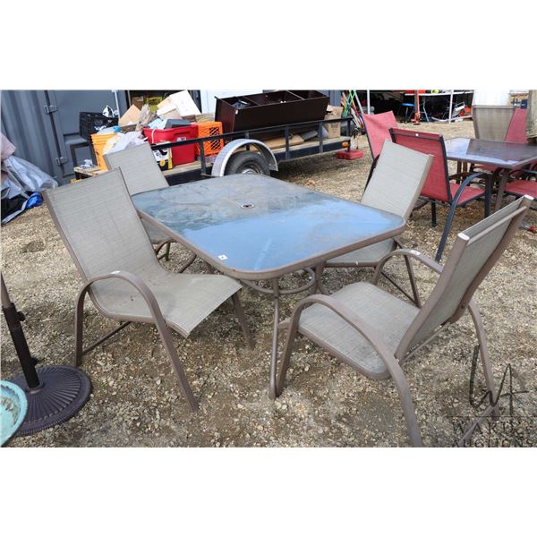 5 piece patio furniture set including 56"x36" glass top table and 4 metal framed chairs