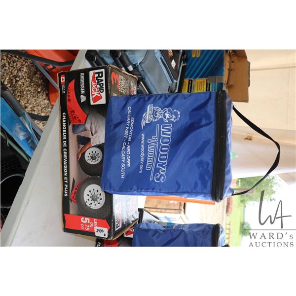 Boxed Anderson Rapid Jack tire change system and a set of Woodys RV leveling blocks